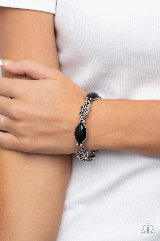 Garden Rendezvous - Black and Silver Stretchy Bracelet - Paparazzi Accessories - Shiny black beads, set in daintily studded silver frames, mingle with frames of swirling silver filigree as they alternate along stretchy bands for a whimsically wild fashion around the wrist.