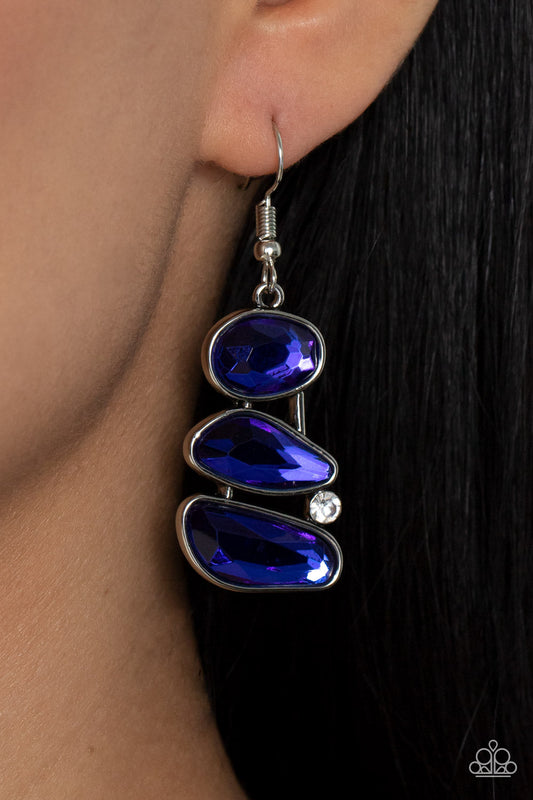 Gem Galaxy - Blue and Silver Earrings - Paparazzi Accessories - Infused with a solitaire white rhinestone, an asymmetrical series of glittery blue gems delicately stack into an out-of-this-world centerpiece. Earring attaches to a standard fishhook fitting. Sold as one pair of earrings.