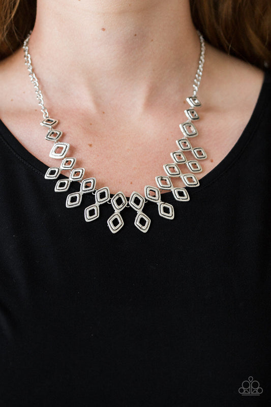 Geocentric - Silver Fashion Necklace - Paparazzi Accessories - Brushed in an antiqued shimmer, glistening diamond-shaped silver frames link below the collar, coalescing into an edgy geometric fringe. Features an adjustable clasp closure. Sold as one individual necklace.