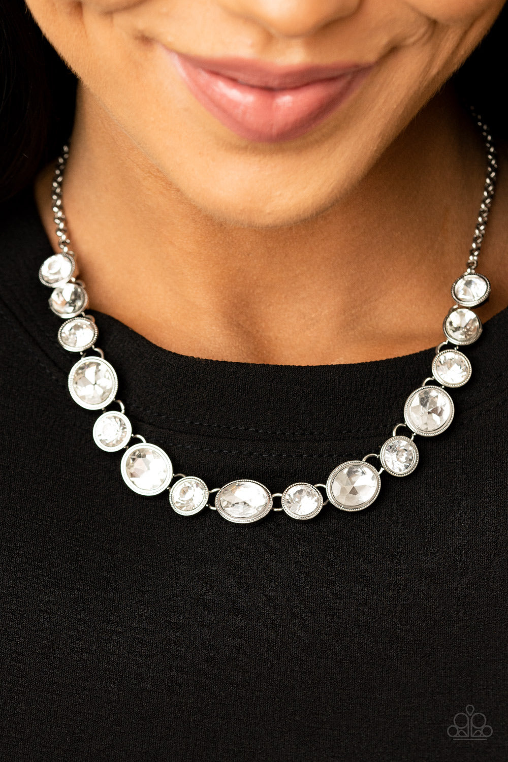 Girls Gotta Glow - White and Silver Necklace - Paparazzi Accessories - Encased in sleek silver frames, oval and round white rhinestones alternate below the collar for a timeless look. Features an adjustable clasp closure. Sold as one individual necklace.