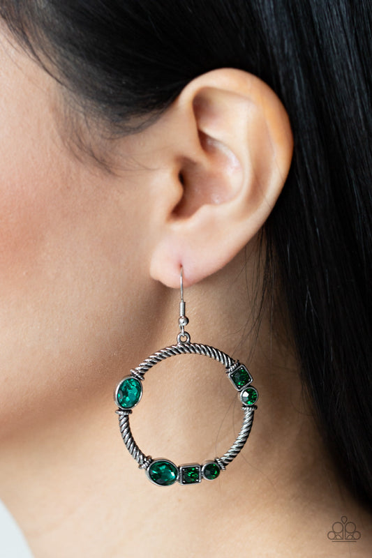 Glamorous Garland - Green and Silver Earrings - Paparazzi Accessories - Featuring round, oval, and square cuts, a collection of glittery green rhinestones haphazardly adorn the front of a textured silver hoop, for a gritty-glamorous look. Earring attaches to standard fishhook fittings. Sold as one pair of earrings.