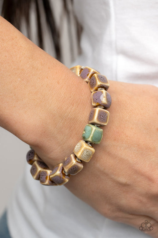 Glaze Craze - Purple and Brown Ceramic Bracelet - Paparazzi Accessories - Featuring distressed purple, blue, and brown glazed finishes, a rustic collection of ceramic cube beads are threaded along stretchy bands around the wrist for a colorful flair.