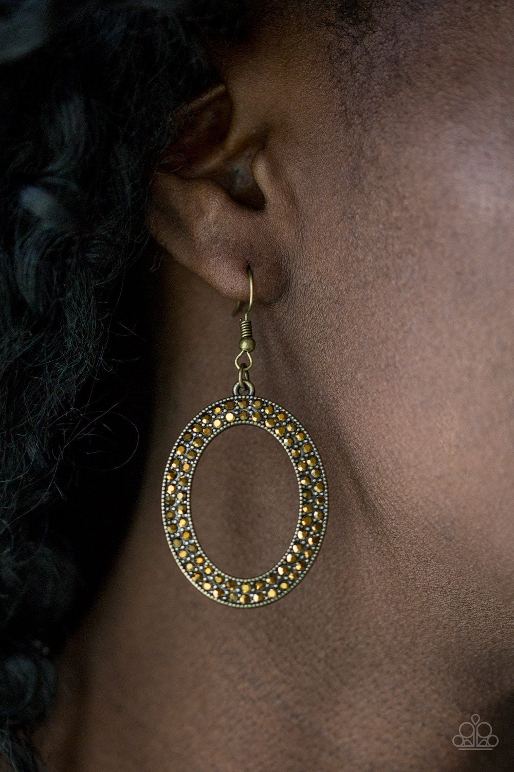 Go Down In Glitter - Brass Fashion Earrings - Paparazzi Accessories - Encrusted in two rows of glassy aurum rhinestones, a shimmery brass hoop swings from the ear in a glamourous fashion. Earring attaches to a standard fishhook fitting. Sold as one pair of earrings.