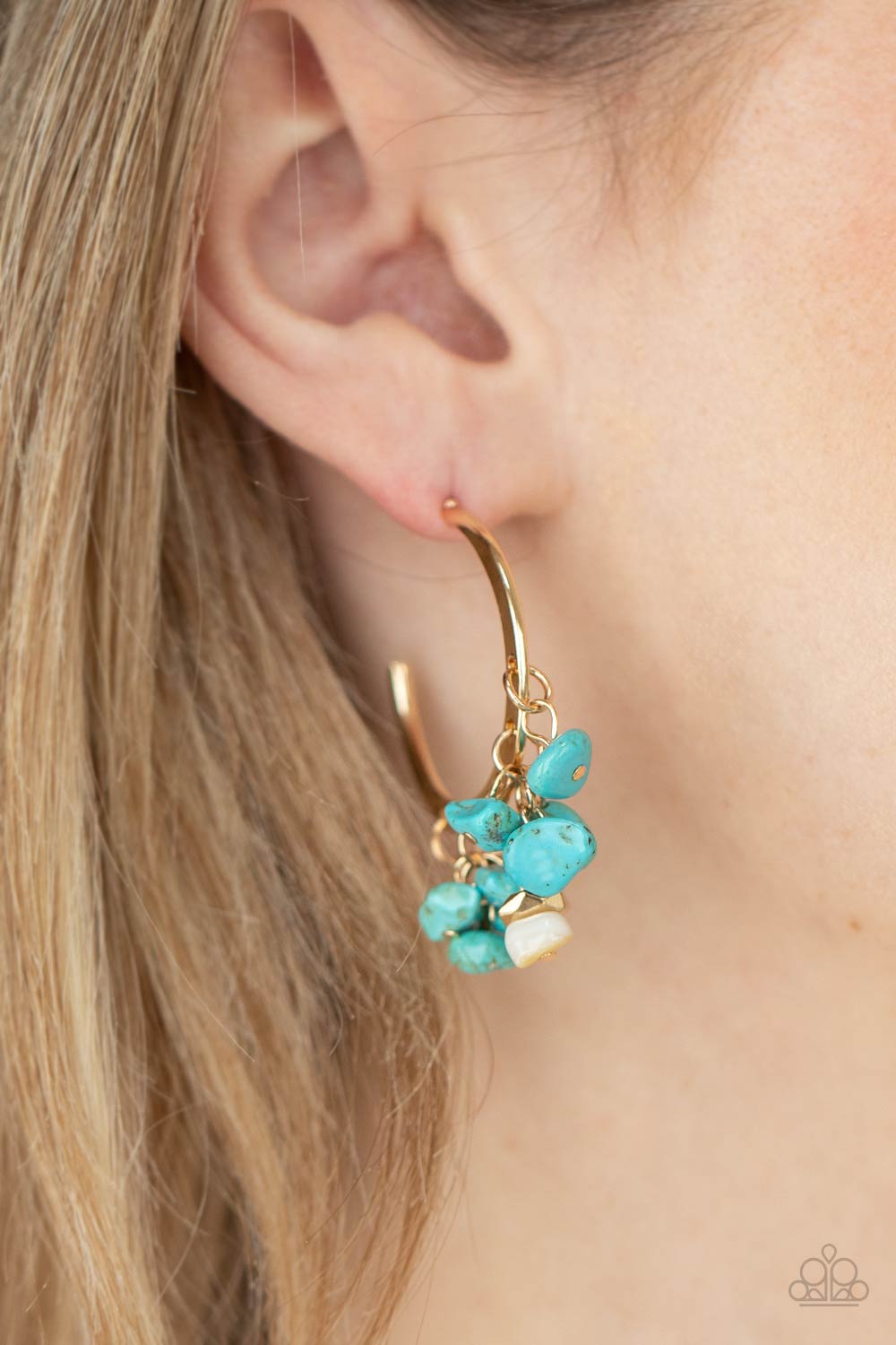 Gorgeously Grounding - Gold - Turquoise Hoop Earrings - Paparazzi Accessories - 
Clusters of turquoise pebbles swing from the bottom of a dainty gold hoop, creating an earthy fringe. A faceted gold and white stone bead swings from the center, adding an ethereal edge. Earring attaches to a standard post fitting. Hoop measures approximately 1 1/4" in diameter.
Sold as one pair of hoop earrings.
