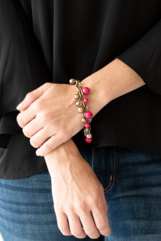 Grit and Glamour - Pink and Brass Bracelet - Paparazzi Accessories - Pearly brass, polished pink, and glittery crystal-like beads swing from a bold brass chain, creating a refined fringe around the wrist. Features an adjustable clasp closure fashion bracelet.