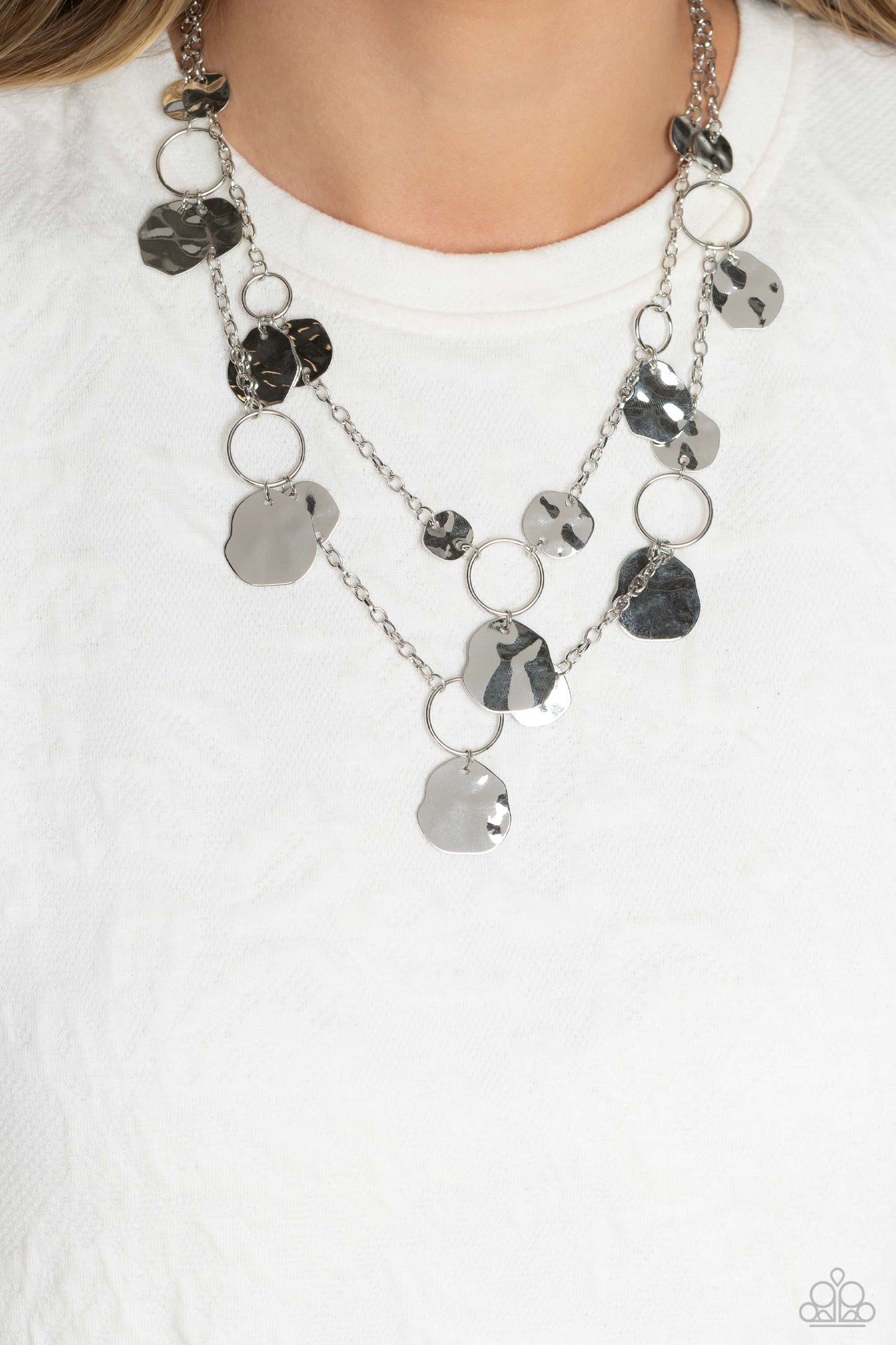 Hammered Horizons - Silver Necklace - Paparazzi Accessories - Infused along two silver chains, smooth silver hoops and abstract, hammered silver discs fall down the neckline for an edgy, boisterous display. 