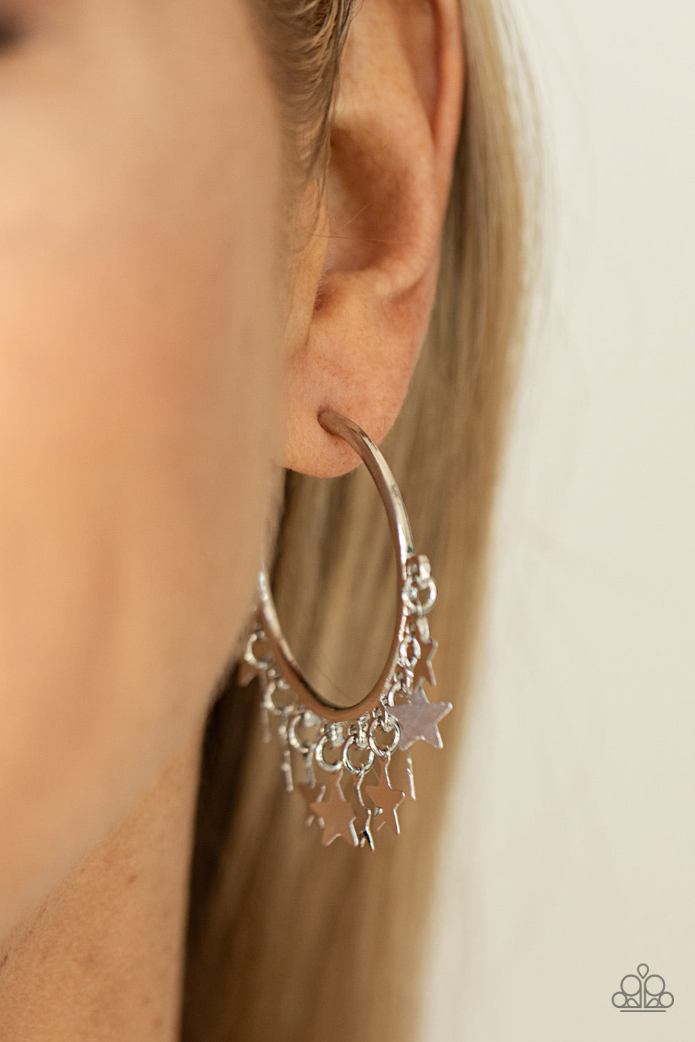 Happy Independence Day - Silver Star Charm Earrings - A shiny collection of silver star charms trickles from the bottom of a classic silver hoop, creating a stellar fringe. Earring attaches to a standard post fitting. Hoop measures approximately 1 1/4" in diameter. Sold as one pair of hoop earrings.