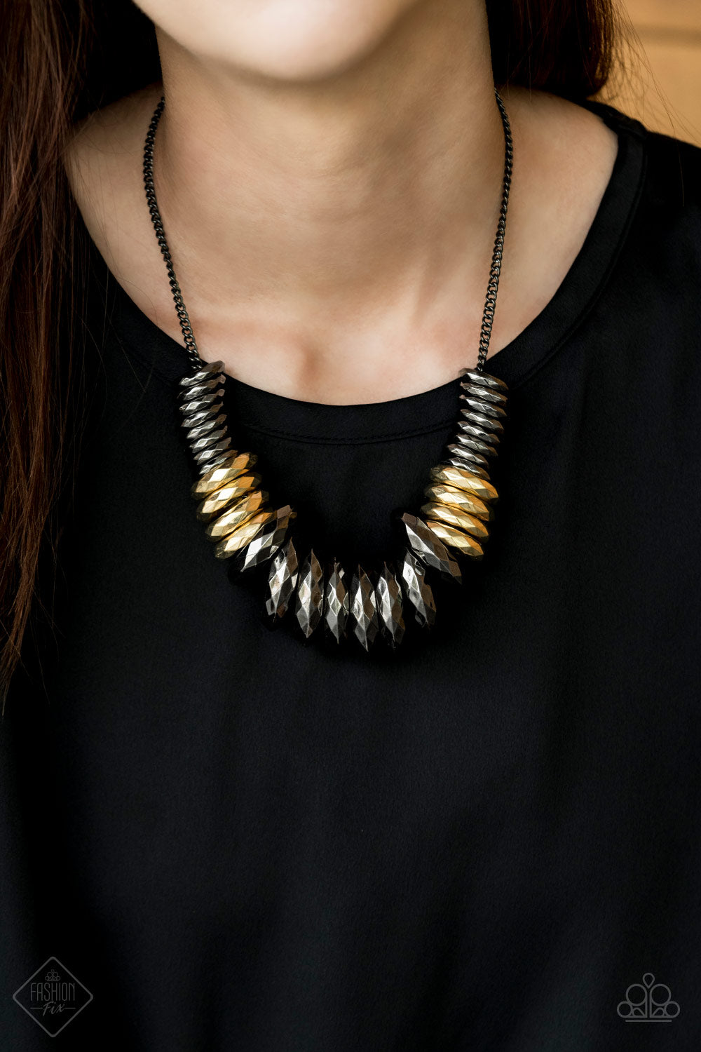 Haute Hardware - Gold and Black Necklace - Paparazzi Accessories - Gradually increasing in size, a collision of faceted gunmetal and gold rings slides along a classic gunmetal chain below the collar, creating a bold industrial statement piece. Features an adjustable clasp closure. Sold as one individual necklace.