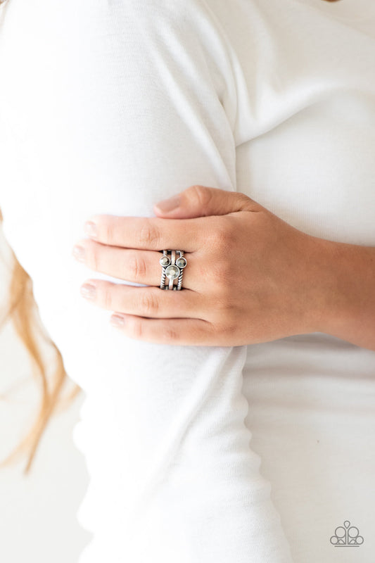 Head In The Stars - Silver - Hematite Ring - Paparazzi Accessories - A trio of glittery hematite rhinestones are sprinkled along smooth and twisted silver bands, creating edgy layers across the finger. Features a stretchy band for a flexible fit. Sold as one individual ring.