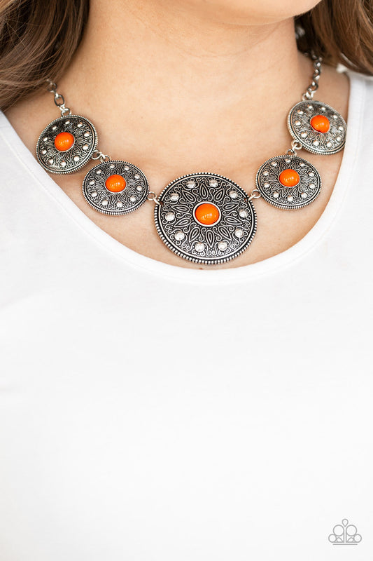 Hey, SOL Sister - Orange and Silver Necklace - Paparazzi Accessories - Round silver frames radiating with sunburst patterns link below the collar. Infused with shiny silver studs, the tribal inspired frames are dotted with robust orange beaded centers for a colorful necklace. 