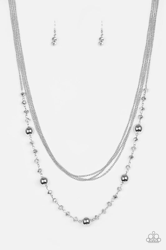 High Standards - Silver Layered Necklace - Paparazzi Accessories - Infused with rows of shimmery silver chains, a strand of glittery metallic crystal-like beads and classic silver accents drape across the chest for a regal finish. Features an adjustable clasp closure. Sold as one individual necklace.
