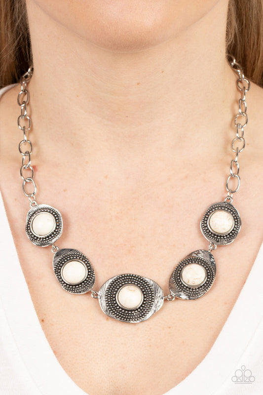 Homestead Harmony - White Crackle and Silver Necklace - Paparazzi Accessories - Refreshing white stones dot the centers of wavy irregular-shaped frames. Embellished with studded and etched feathery texture, the rustic frames create an earthy artisanal display below the collar. Features an adjustable clasp closure. Sold as one individual necklace.