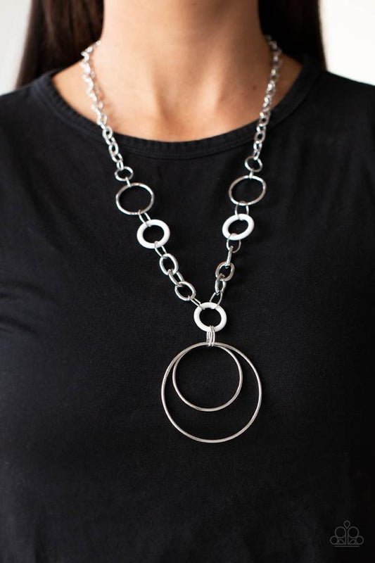 HOOP du Jour - White and Silver Fashion Necklace - Paparazzi Accessories - Two generously sized hoops dangle from an oversized chain accented with small white acrylic hoops to create a playful pendant. Features an adjustable clasp closure.