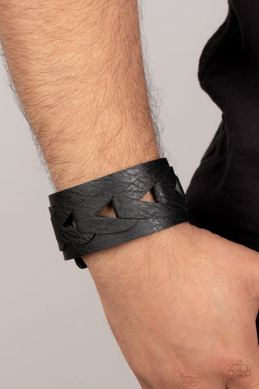 Horse and Carriage - Black Leather Urban Bracelet - Paparazzi Accessories - Featuring airy triangular cutouts, black leather links interlock across the center of a distressed black leather band for a rustic flair bracelet.