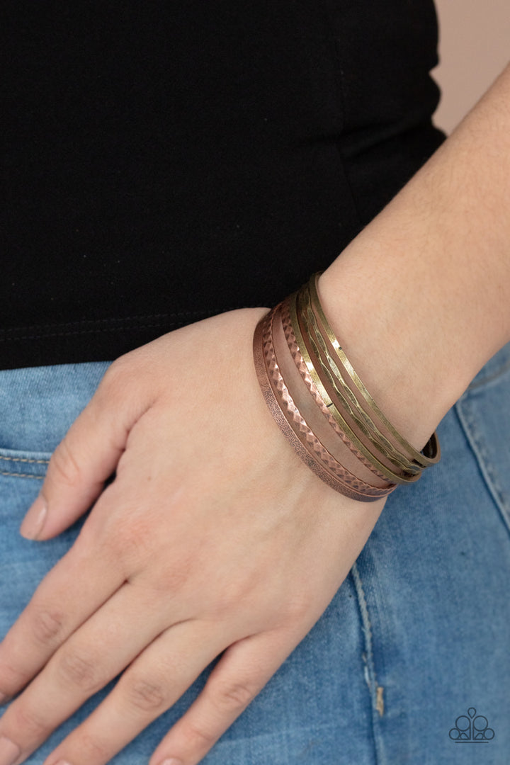 How Do You Stack Up? - Multi Metal (Brass and Copper) Bracelet - Paparazzi Accessories Bejeweled Accessories By Kristie - Varying in hammered, diamond-cut, and shiny finishes, a collection of mismatched copper and brass bangles stack across the wrist for an intense industrial look. Sold as one set of seven bracelets.