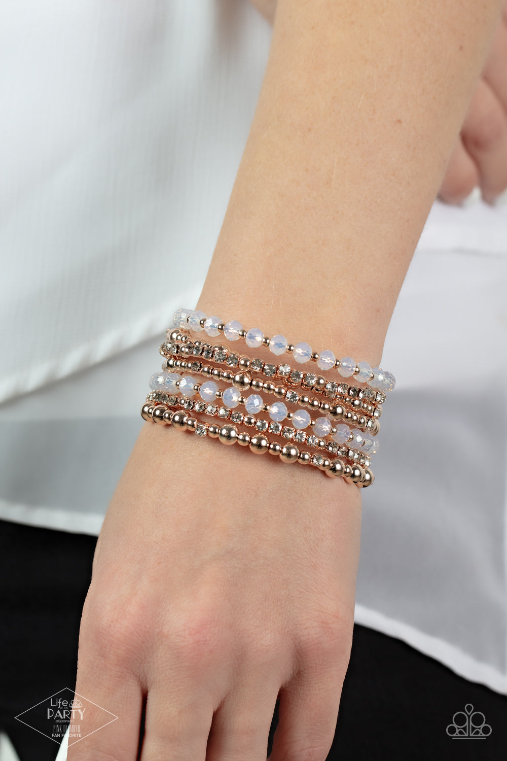 ICE Knowing You - Rose Gold Coil Fashion Bracelet - Paparazzi Accessories - An icy collection of rose gold beads, rose gold cubes, opaque crystals, and glassy white rhinestones are threaded along a coiled wire, creating a blinding infinity wrap style bracelet around the wrist.