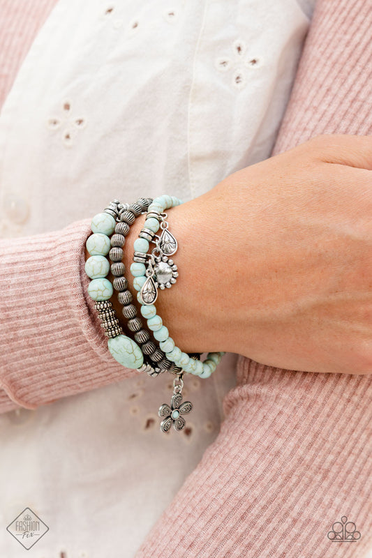 Individual Inflorescence - Blue and Silver Floral and Leaf Charm Bracelet - Paparazzi Accessories - A trio of floral-inspired bracelets, featuring comfortable stretchy bands and smooth light blue stones, stack along the wrist to create a bold statement piece. Sold as one set of three bracelets.