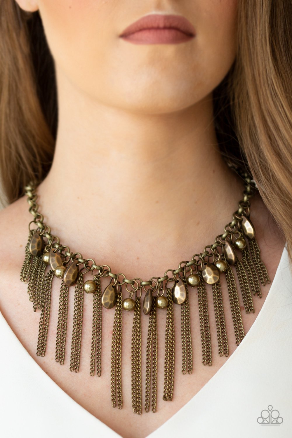 Industrial Intensity Brass Necklace - Paparazzi Accessories - A collection of faceted brass teardrops and pearly brass beads drip from the bottom of an antiqued brass chain. Pairs of brass chains stream from the bottom of the chain, creating an intensely tapered fringe below the collar. Features an adjustable clasp closure. Sold as one individual necklace. 