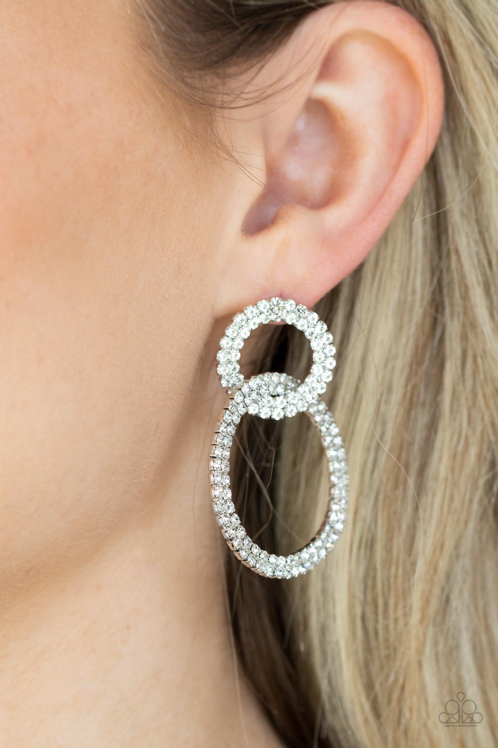 Intensely Icy - White Sparkly Earrings - Paparazzi Accessories - Rows of sparkly white rhinestones encircle into two interconnected hoops, creating a jaw-dropping unique earrings.  Bejeweled Accessories By Kristie - Trendy fashion jewelry for everyone -
