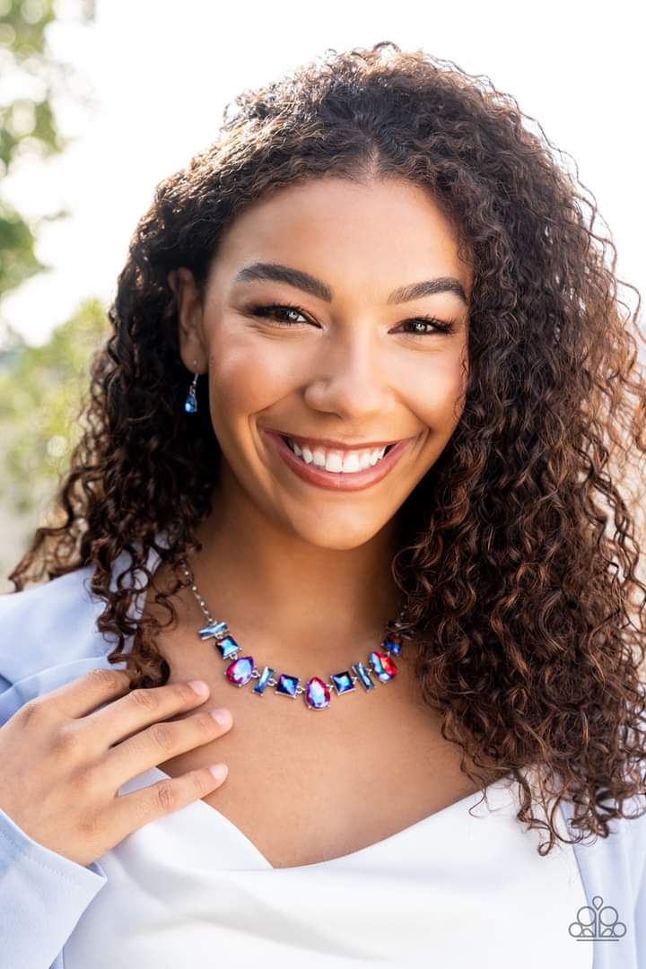 Interstellar Ice - Pink and Blue - Iridescent - Oil Spill - Silver Necklace - Paparazzi Accessories - Glassy, iridescent, and oil spill finishes, a mismatched collection of emerald cut blue, square multicolored, and teardrop pink gems delicately connects below the collar for a stellar statement. Features an adjustable clasp closure.