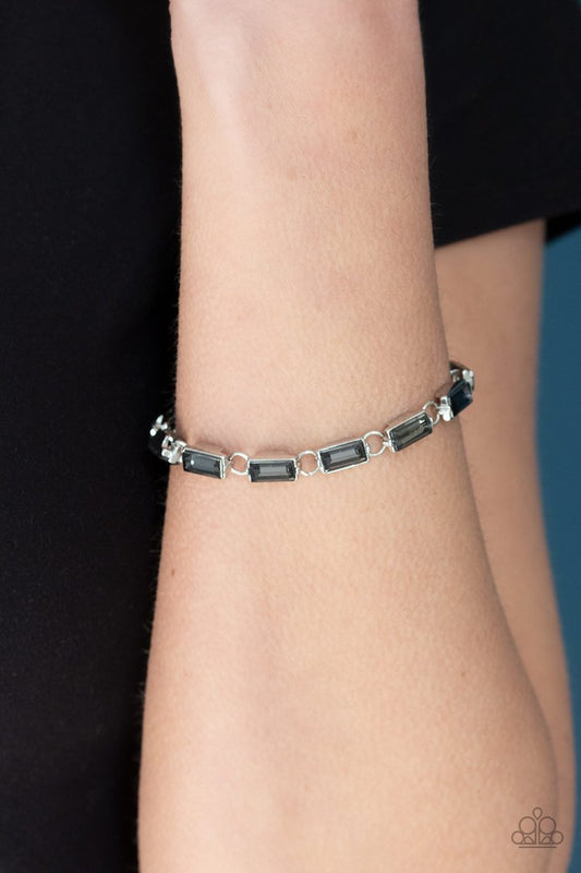 Irresistibly Icy - Smoky Silver Bracelet - Paparazzi Accessories - 
Featuring sleek silver frames, a glittery collection of emerald cut smoky rhinestones delicately link across the wrist for a glamorous look. Features an adjustable clasp closure. Sold as one individual bracelet.
