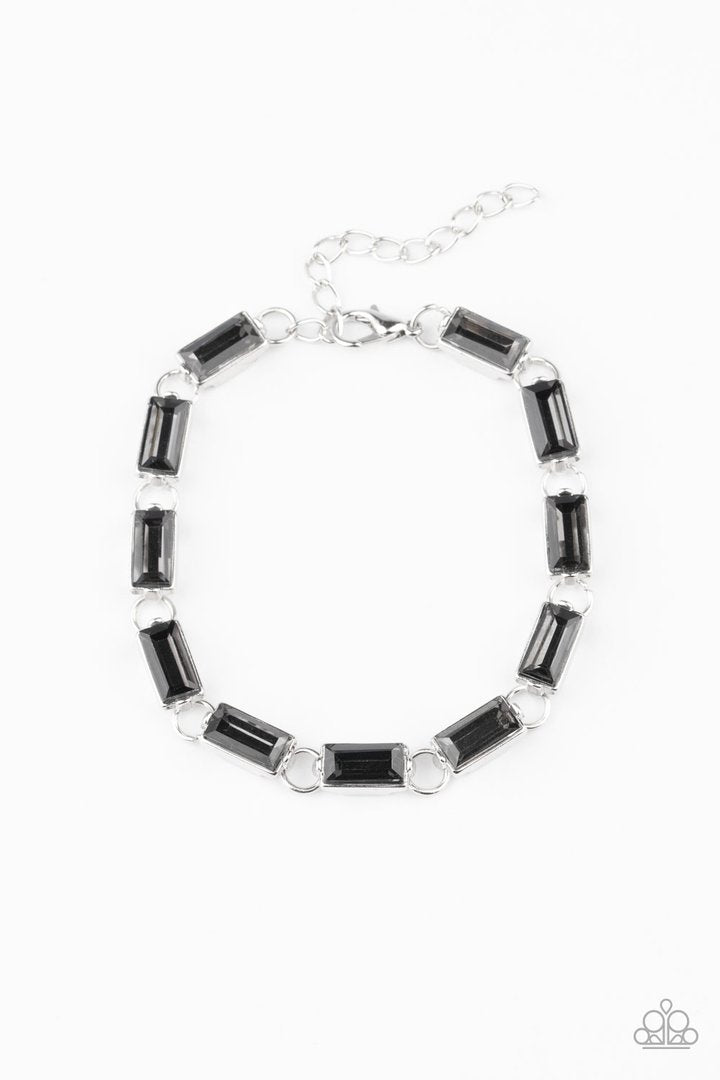 Irresistibly Icy - Smoky Silver Bracelet - Paparazzi Accessories - 
Featuring sleek silver frames, a glittery collection of emerald cut smoky rhinestones delicately link across the wrist for a glamorous look. Features an adjustable clasp closure. Sold as one individual bracelet.
