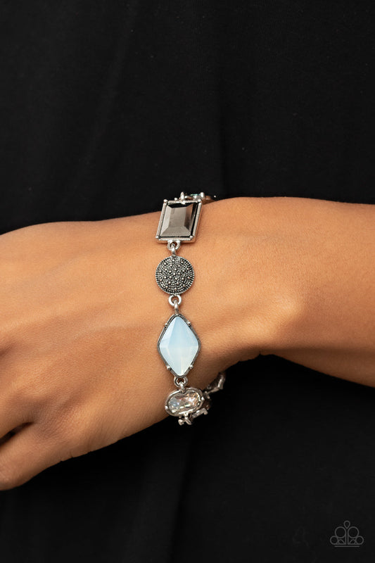 Jewelry Box Bauble - Opal - Hematite - Silver Bracelet - Paparazzi Accessories - Encased in pronged silver fittings, a mismatched collection of white, hematite, and opal rhinestones delicately links with a studded silver frame around the wrist for a sentimental sparkle. Features an adjustable clasp closure.