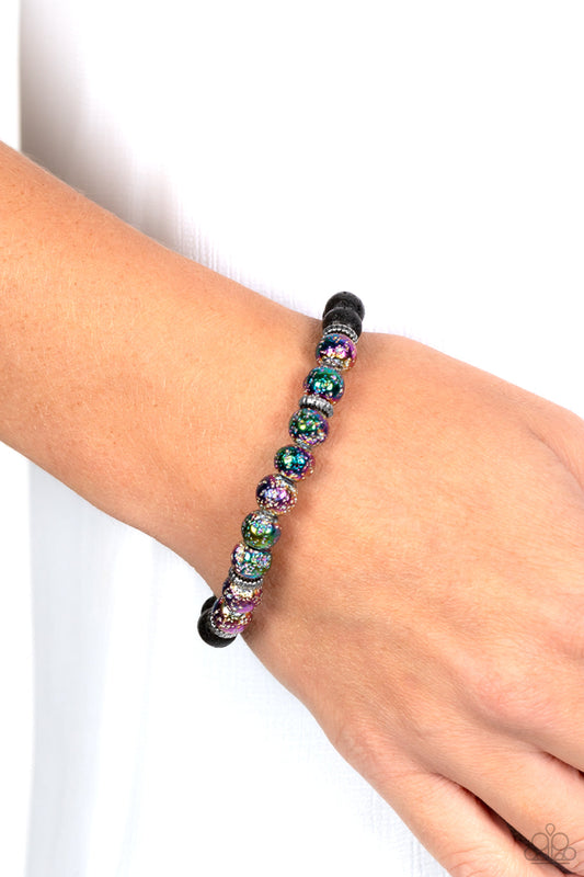 LAVA Story - Multi Color - Lava Rock Bracelet - Paparazzi Accessories - A stellar assortment of oil spill lava rock beads, silver accents, and black lava rock beads are threaded along an elastic stretchy band around the wrist for an urban flair bracelet.