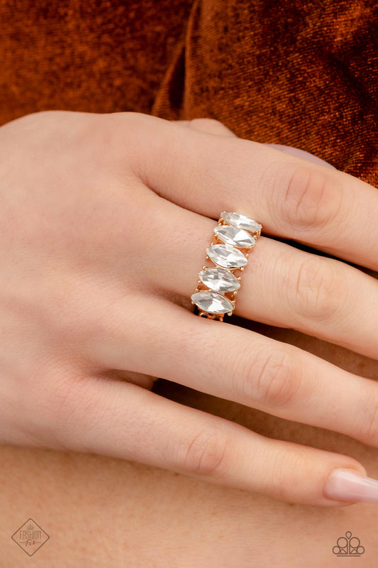 Lavish Lure - Gold Fashion Ring - Paparazzi Accessories - Exaggerated white marquise-cut gems are set atop pronged gold fittings, that arc across the finger in a linear pattern for a scintillating shimmer. Features a stretchy band for a flexible fit. Sold as one individual ring.
