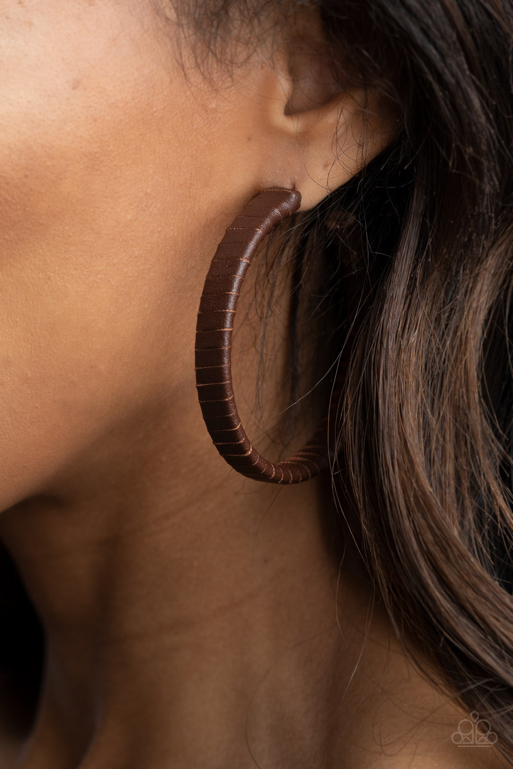 ​Leather-Clad Legend - Brown Leather Hoop Earrings - Paparazzi Accessories - 
A rustic brown leather lace wraps around a thick silver hoop, creating an edgy display. Earring attaches to a standard post fitting. Hoop measures approximately 2 1/2" in diameter.
Sold as one pair of hoop earrings.
