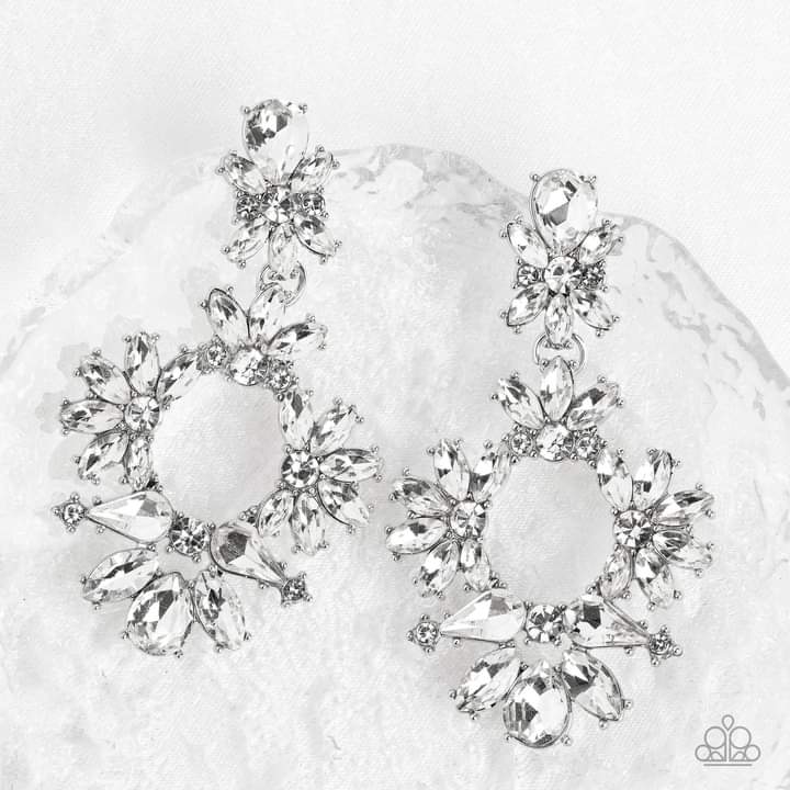 Leave them Speechless - White and Silver Dazzling Earrings - Paparazzi Accessories - Ablaze with a mismatched assortment of brilliant white rhinestones, a stunning wreath swings from the bottom of a dainty white rhinestone fitting for a jaw-dropping dazzle earrings.