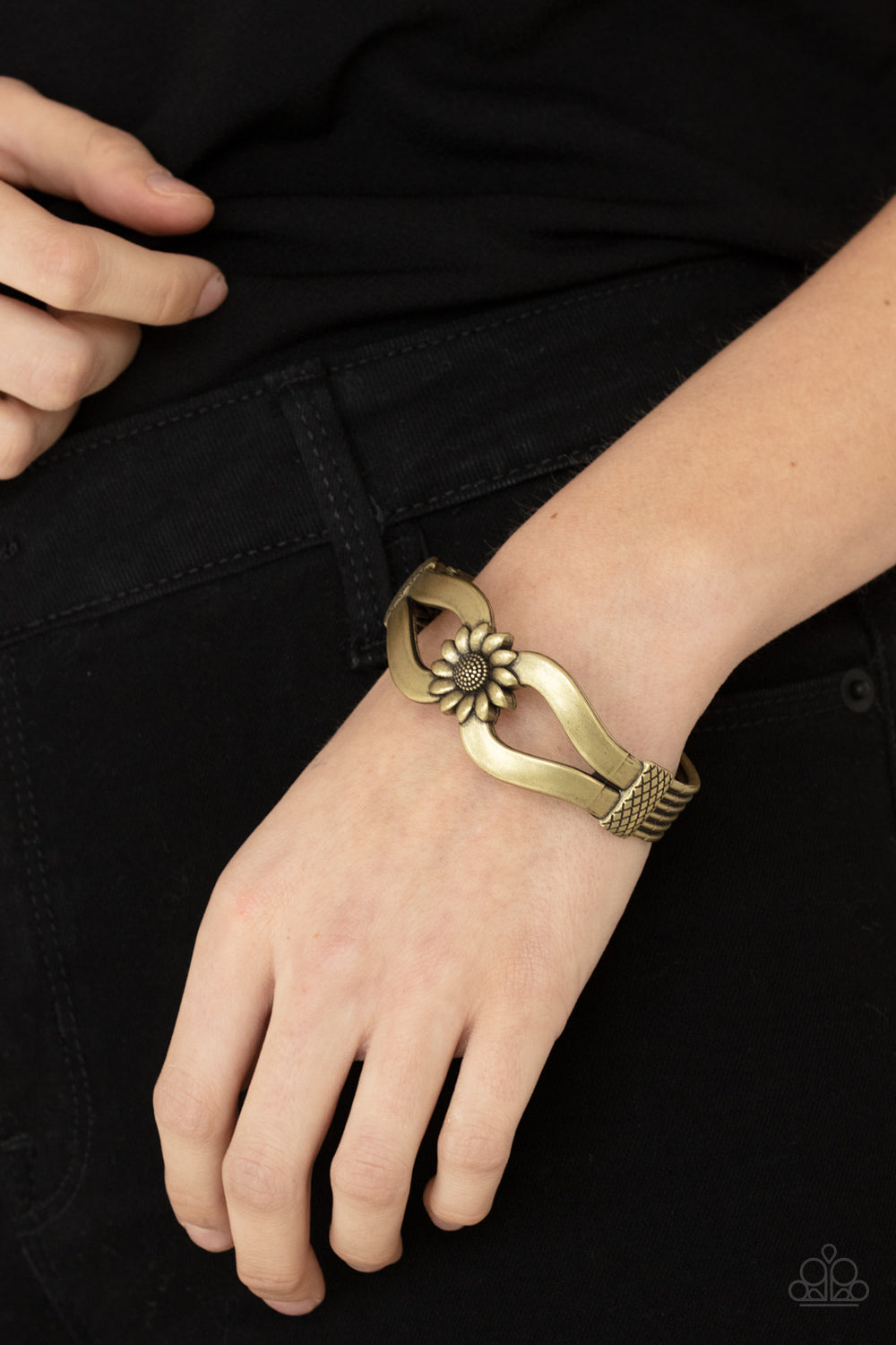 ​Let A Hundred SUNFLOWERS Bloom - Brass Cuff Hinged Bracelet - Paparazzi Accessories - Antiqued brass ribbons loop out from a decorative brass sunflower that attaches to a ribbed brass frame, creating a cuff-like bangle around the wrist. Features a hinged closure. Sold as one individual fashion bracelet.