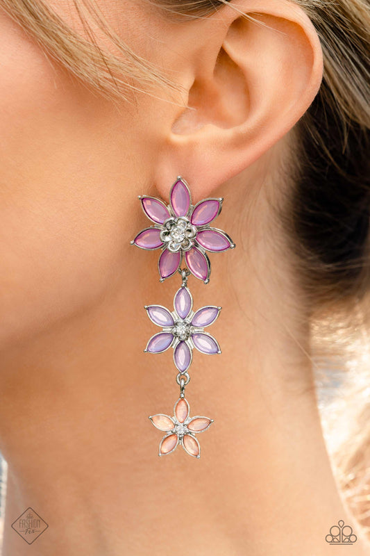 Lets Get it GARLAND - Multi Lavender Earrings - Paparazzi Accessories - Glassy marquise-cut petals in shades of orchid, lavender, and Peach Pink fan out around silver centers topped with sparkling white gems. The vibrant flowers gradually decrease in size as they fall from the ear, bringing whimsical movement to the colorful cascade.