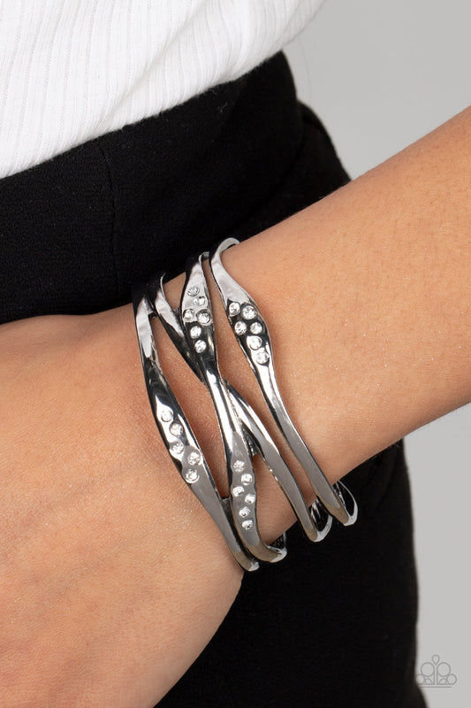 Line It Up - White and Silver Fashion Bracelet - Paparazzi Accessories - Dusted in sections of dainty white rhinestones, asymmetrical silver bars boldly crisscross the wrist into a gritty yet glamorous cuff. Sold as one individual bracelet.