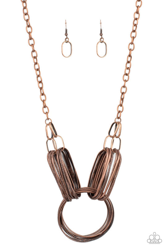 Lip Sync Links - Copper Necklace - Paparazzi Accessories - Layers of oblong copper links attach to a collection of oversized antiqued copper rings creating a dramatic centerpiece. Attached to a copper chain, the rustic links create an unconventionally edgy statement below the collar.