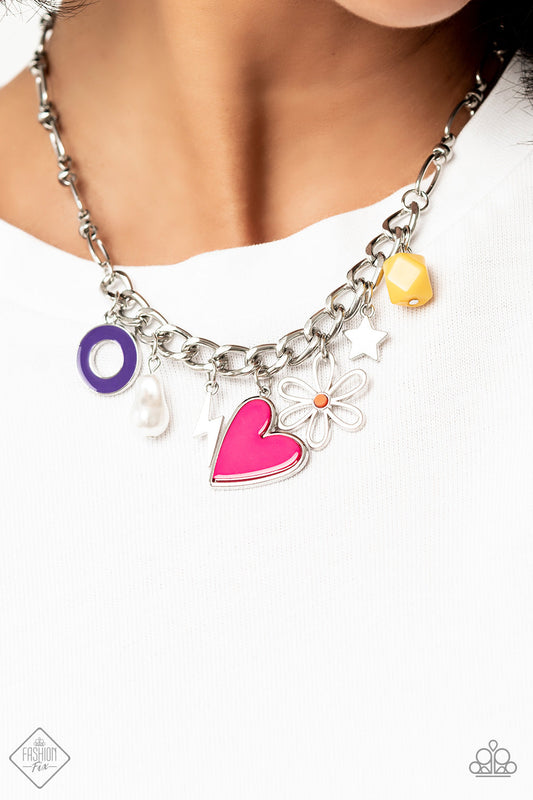 Living in CHARM-ony - Multi Color Charms Necklace - Paparazzi Accessories - Elongated silver chain links, separated by tiny silver beads, lead down the neckline to a section of thick, flat, silver curb chain. A collection of whimsical charms gather along the thicker chain, including a lightning bolt, a star, a purple ring, a silhouette of a flower, a vibrant yellow bead, a pink heart, and a polished white baroque pearl.