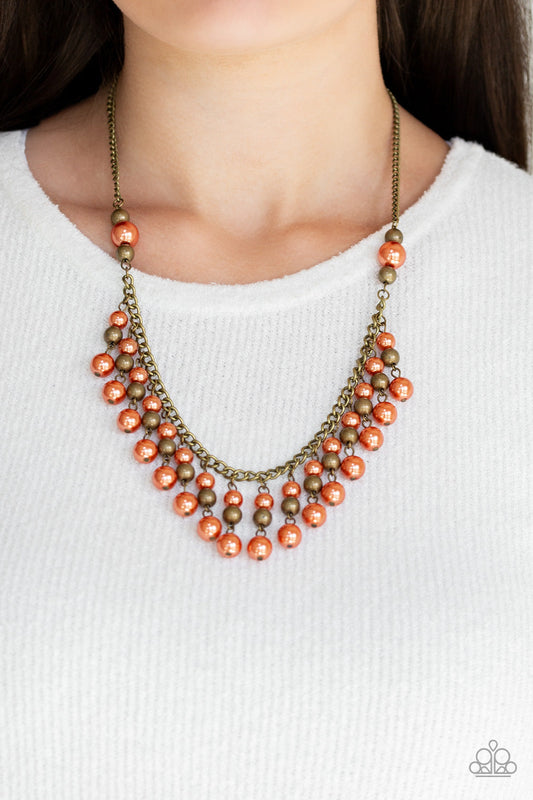 Location, Location, Location! - Orange and Brass Necklace - Paparazzi Accessories - Pearly orange and brass beaded tassels swing from the bottom of a glistening brass chain, creating a refined fringe below the collar. Features an adjustable clasp closure.