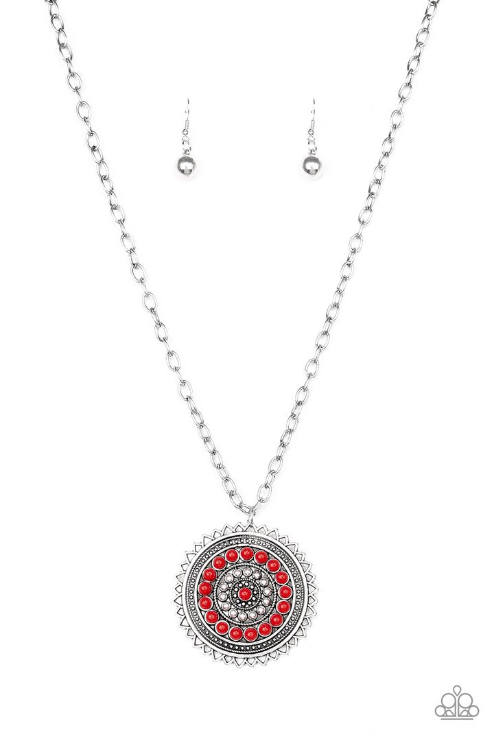 Lost SOL - Red and Silver Necklace - Paparazzi Accessories - Radiating with shimmery sunburst details, a red beaded silver pendant swings from the bottom of a lengthened silver chain for a tribal inspired style necklace.