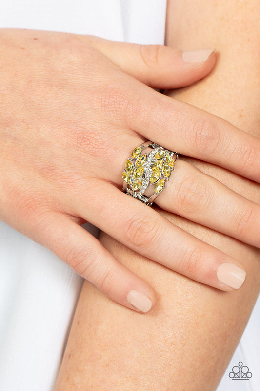 Luminously Leafy - Yellow and Silver Ring - Paparazzi Accessories - Clusters of yellow marquise-cut crystals flank a wavy band of dainty white rhinestones atop the finger. The yellow crystals fall into a leafy pattern, adding a touch of earthy elegance to the luminously layered look. Features a stretchy band for a flexible fit. Sold as one individual ring.