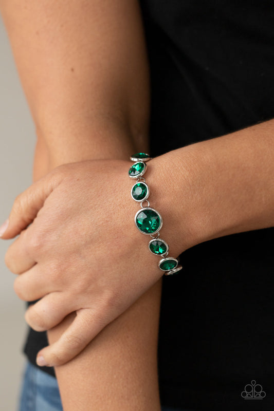 ​Lustrous Luminosity - Green Gem and Silver Bracelet - Paparazzi Accessories - Featuring sleek silver fittings, an oversized collection of sparkly green gems delicately link around the wrist. The centermost gem is slightly larger than the rest, adding a glamorous finish. Features an adjustable clasp closure. Sold as one individual fashion bracelet. 