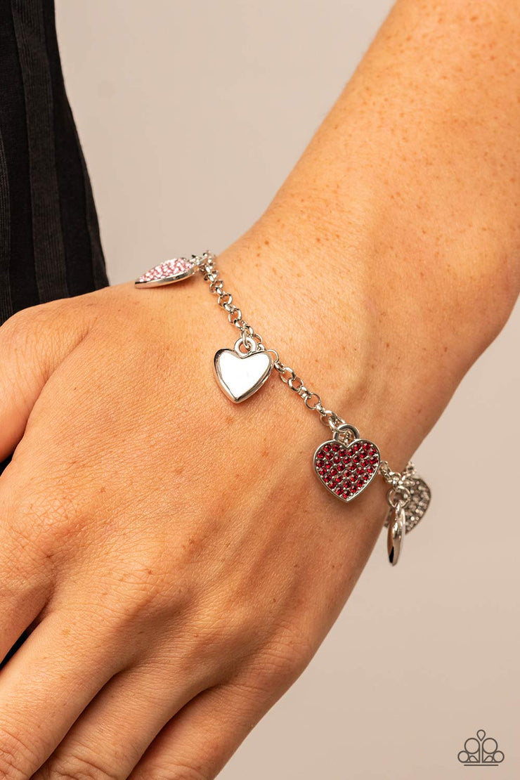 Lusty Lockets - White - Red - Pink Heart Charm - Silver Fashion Bracelet - Paparazzi Accessories - Shiny silver heart charms delicately alternate with white, red, and pink rhinestone encrusted heart frames along a silver chain around the wrist, resulting in a flirtatious fringe. Features an adjustable clasp closure. Sold as one individual fashion bracelet.