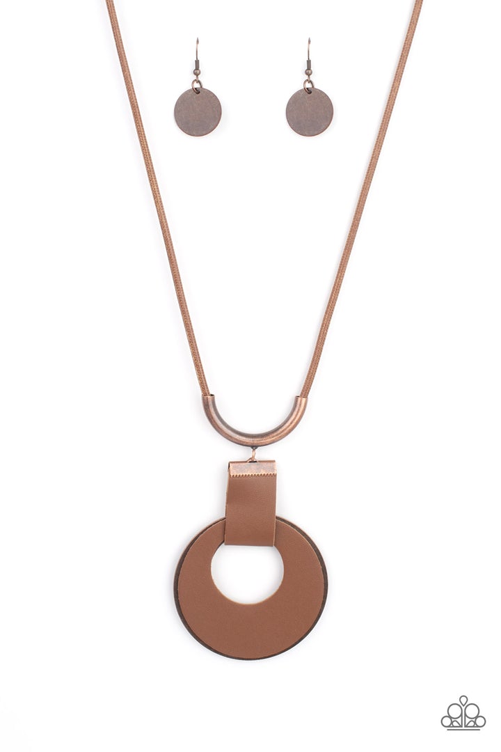 Luxe Crush - Copper Brown - Leather Necklace - Paparazzi Accessories - Bejeweled Accessories By Kristie - A large cutout copper disc, overlaid with brown leather, is cradled in a wide brown leather strap. The luxe pendant sways from a U-shaped copper cylinder threaded along the end of a lengthened polished brown cord for an indulgently lavish finish. Features a sliding bead closure necklace.