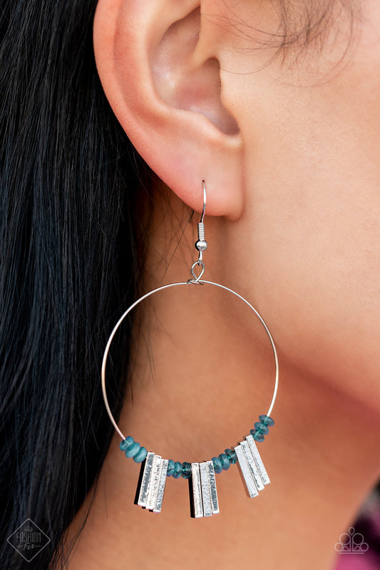 Luxe Lagoon - Blue and Silver Earrings - Paparazzi Accessories - Tiny Harbor Blue beads are threaded along the bottom edge of a skinny silver hoop. The beads are separated by sections of rectangular silver bars that accentuate the curvature of the hoop, resulting in a flared design that demands attention. Earring attaches to a standard fishhook fitting. Sold as one pair of earrings.