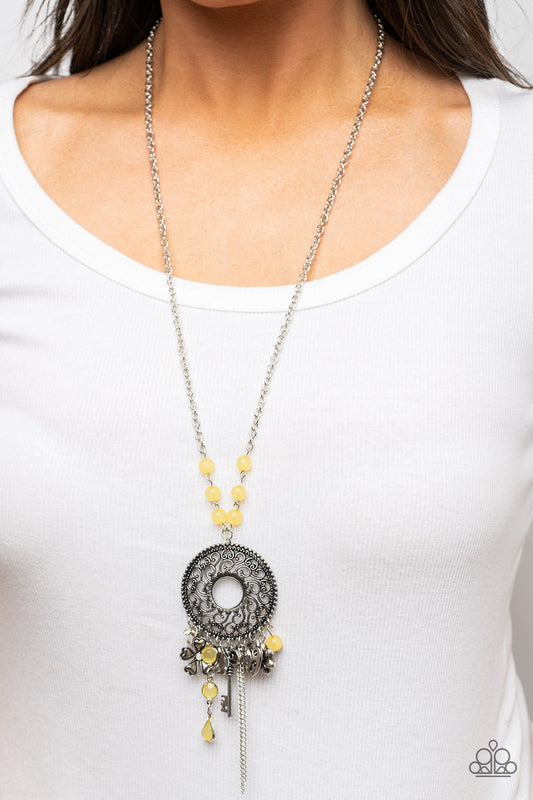 Making Memories - Yellow and Silver Charms Necklace - Paparazzi Accessories - Fashion necklace with glassy yellow beads an assortment of silver key heart and floral charms cascades from an oversized silver pendant with heart shaped vine-like filigree. The frame swings from the bottom of a yellow beaded silver chain, adding a color to the fringe. Features an adjustable clasp closure.