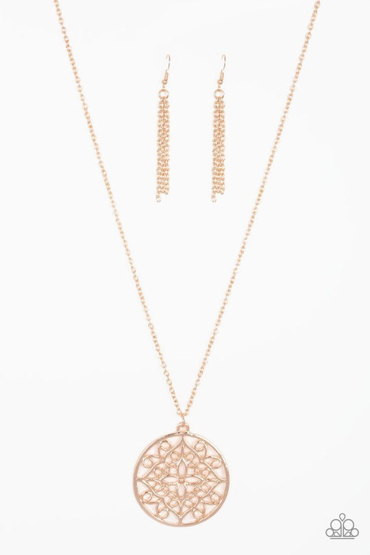 Mandala Melody - Rose Gold Necklace - Paparazzi Accessories - Featuring a whimsical mandala pattern, a glistening rose gold pendant swings from the bottom of a lengthened gold chain for a seasonal look. Features an adjustable clasp closure. Sold as one individual fashion necklace.