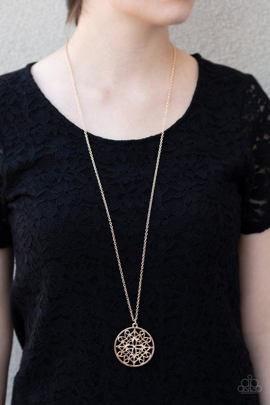 Mandala Melody - Rose Gold Necklace - Paparazzi Accessories - Featuring a whimsical mandala pattern, a glistening rose gold pendant swings from the bottom of a lengthened gold chain for a seasonal look. Features an adjustable clasp closure. Sold as one individual fashion necklace.