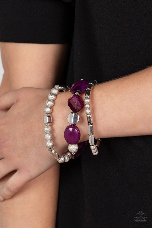 Marina Magic - Plum Purple - Silver Affordable Stretchy Bracelet - Paparazzi Accessories  - Infused with vivacious pops of plum crystal-like and glassy accents, a mismatched assortment of hammered, cube, and faceted silver beads are threaded along stretchy bands around the wrist, creating shimmery layers.