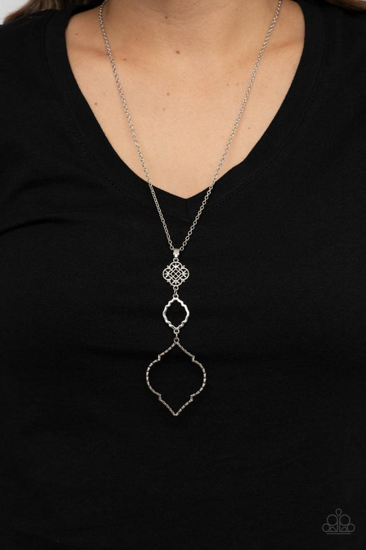 Marrakesh Mystery - Silver Fashion Necklace - Paparazzi Accessories - Featuring mandala-like patterns, a floral lattice frame gives way to mismatched scalloped silver frames, creating a magnificently stacked pendant at the bottom of an extended silver chain.