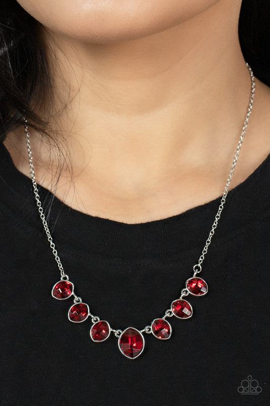 Material Girl Glamour - Red Rhinestone - Silver Necklace - Paparazzi Accessories - Elegant cut fiery red rhinestones delicately connect below the collar. An oversized red rhinestone adorns to the middle of the glittery strand, creating a sparkly centerpiece. Features an adjustable clasp closure. 