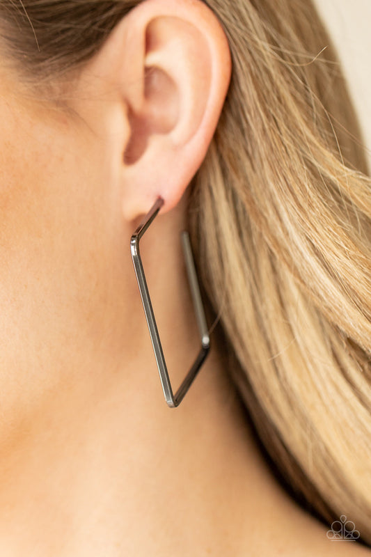 Material Girl Magic - Black - Gunmetal Hoop Earrings - Paparazzi Accessories - A deceptively simple square frame is tilted on point to create a geometric hoop. Its sharp angles are complemented by its rich gunmetal finish, making a lasting impression. Earring attaches to a standard post fitting. Hoop measures approximately 2" in diameter. Sold as one pair of hoop earrings.